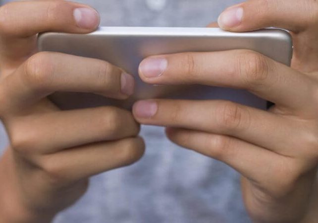 Close up on a boy with a mobile phone